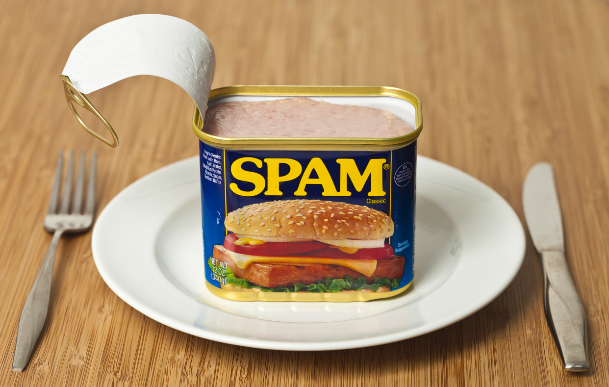 Opened Can of SPAM on a White Plate With Fork and Knife