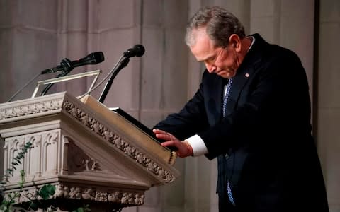 George W Bush's voice cracks as he bids farewell to his father - Credit: AFP