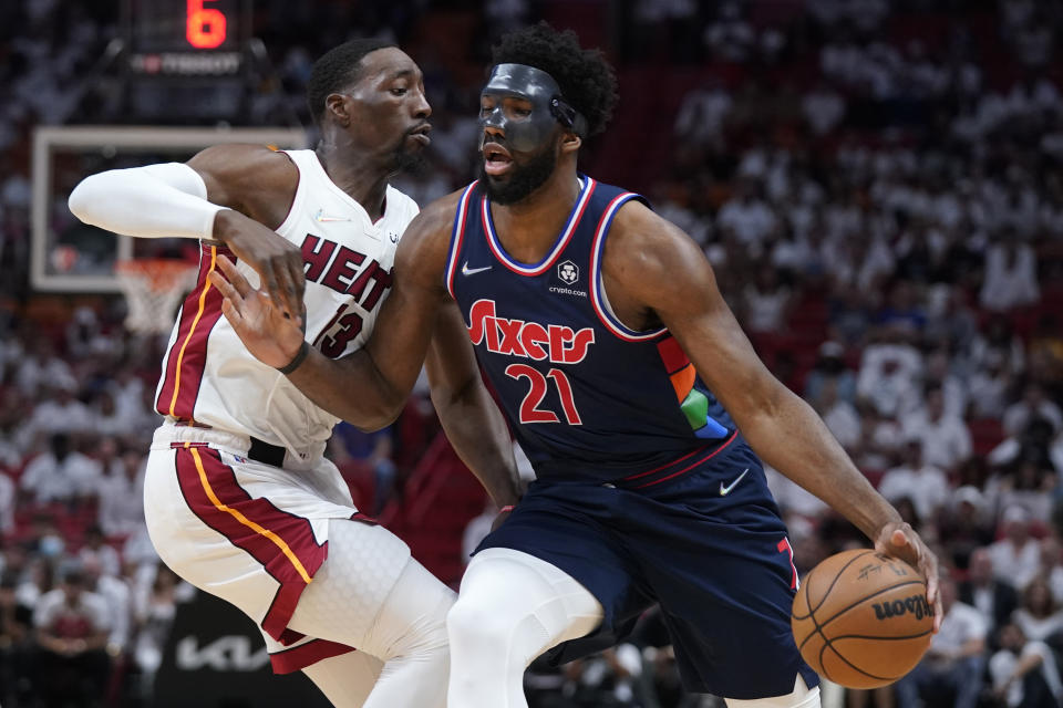 Philadelphia 76ers center Joel Embiid (21) drives up against Miami Heat center Bam Adebayo (13) during the first half of Game 5 of an NBA basketball second-round playoff series, Tuesday, May 10, 2022, in Miami. (AP Photo/Wilfredo Lee)