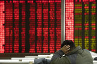 In this Thursday, Dec. 12, 2019, photo, an investor monitors stock prices at a brokerage in Beijing. Shares likewise jumped Friday, Dec. 13, 2019 in Asia following fresh all-time highs overnight on Wall Street spurred by optimism that the U.S. and China are close to reaching a deal to end their costly trade war. (AP Photo/Ng Han Guan)