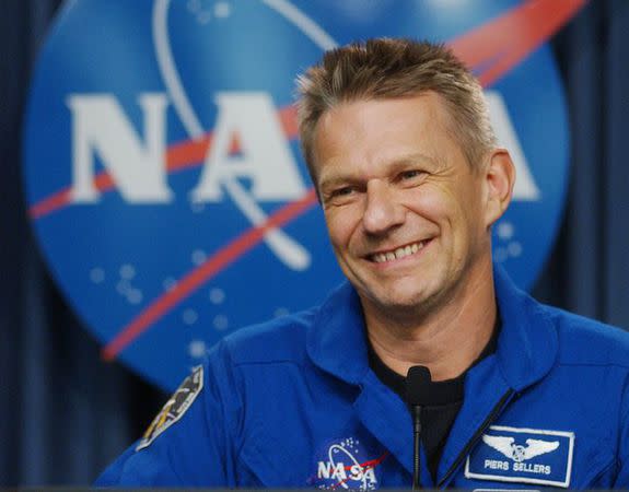 U.S. astronaut Piers Sellers talks with reporters following the safe return the space shuttle Discovery at the Kennedy Space Center in Cape Canaveral.