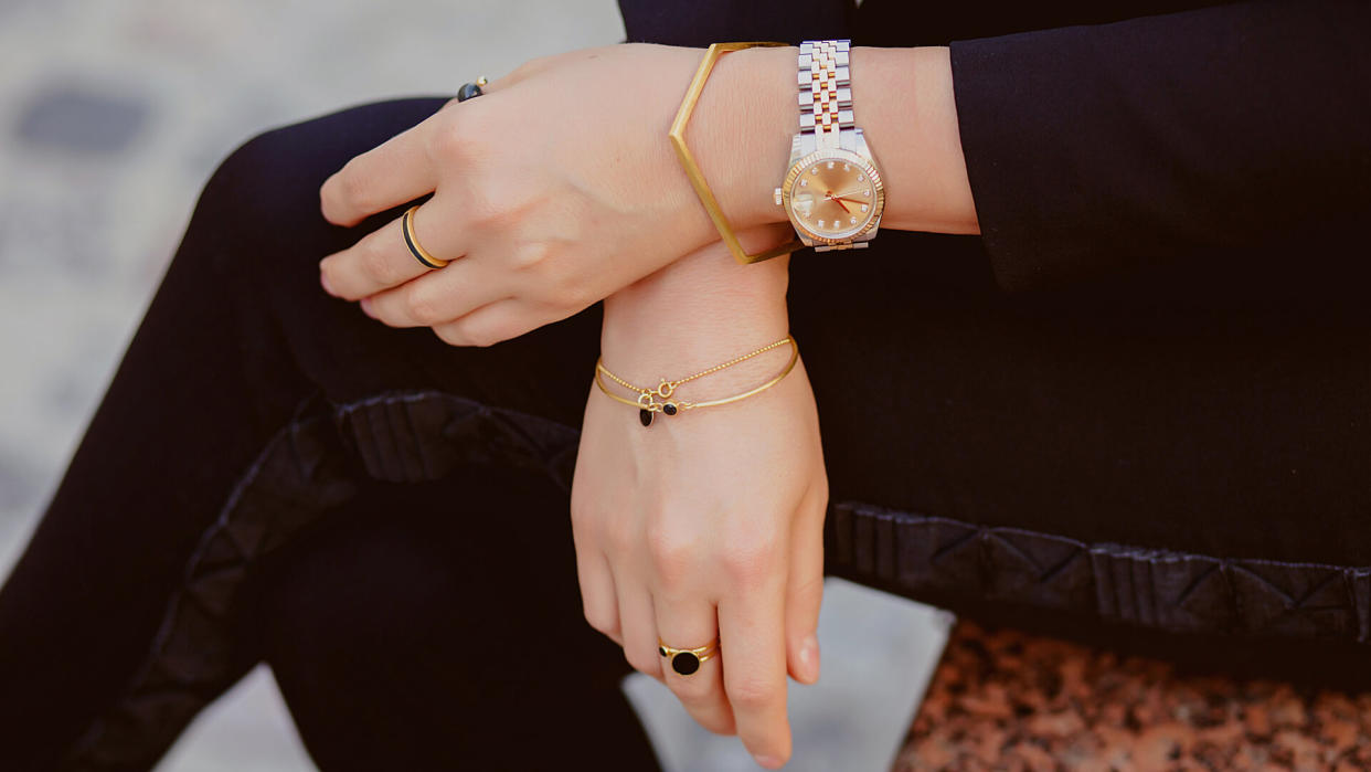 Beautiful jewelry, bracelets, watches, rings, female hands.