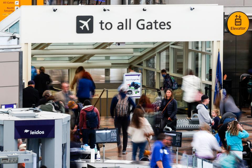 Travelers head toward their gates after passing through a TSA security checkpoint during a winter storm at Denver International Airport on February 22, 2023 in Denver, Colorado.