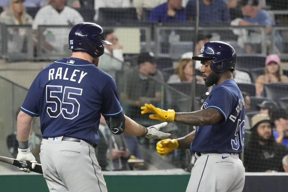 Tampa Bay Rays' Randy Arozarena (56) celebrates with Luke Raley (55) after Arozarena scored on a double by Taylor Walls against the New York Yankees during the seventh inning of a baseball game Thursday, May 11, 2023, in New York. (AP Photo/Mary Altaffer)