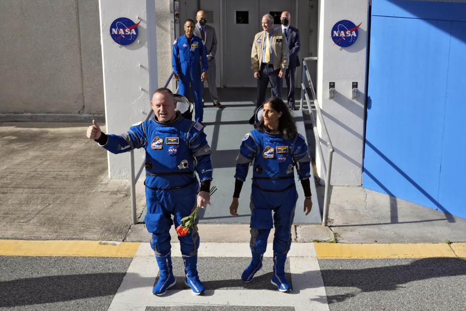 NASA astronauts Butch Wilmore, left, and Suni Williams leave the operations and checkout building for a trip to launch pad at Space Launch Complex 41 Saturday, June 1, 2024, in Cape Canaveral, Fla. The two astronauts are scheduled to liftoff later today on the Boeing Starliner capsule for a trip to the international space station. . (AP Photo/John Raoux)