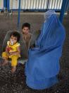 <p>An Afghan refugee woman sits with her children at the registration center of United Nations High Commissioner for Refugees (UNHCR) in the Pakistani city of Peshawar on June 19, 2017 ahead of the World Refugee Day. A record 370,000 Afghans left Pakistan last year, many of whom were second or even third generation migrants of people fleeing the Soviet invasion of Afghanistan during the 1980s, surging from 55,000 the year before. (Photo: Abdul Majeed /AFP/Getty Images) </p>