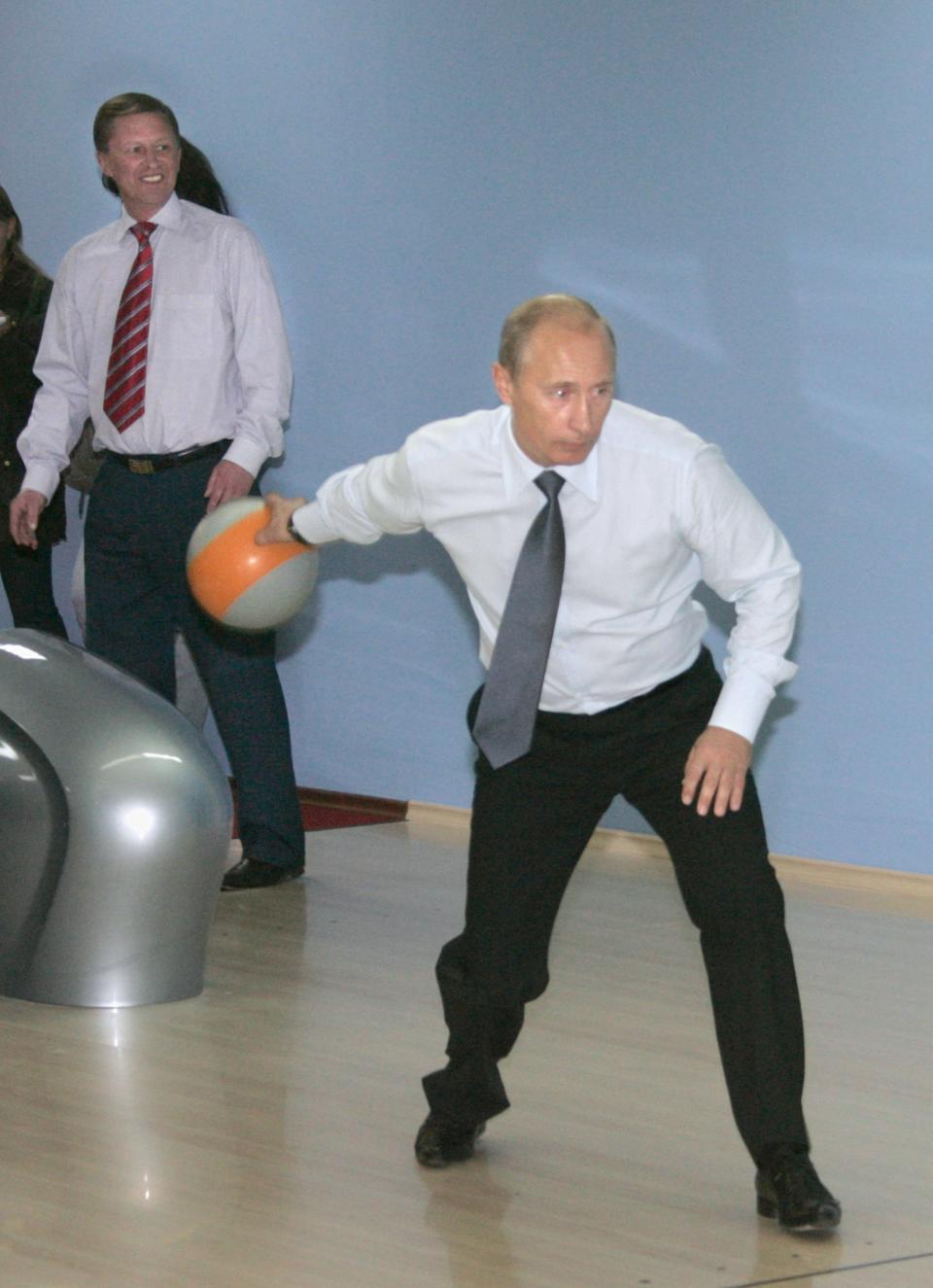 First Deputy Prime Minister Sergei Ivanov looks on as Putin bowls at&nbsp;a new sports complex in Kamchatka on Sept.&nbsp;5, 2007.