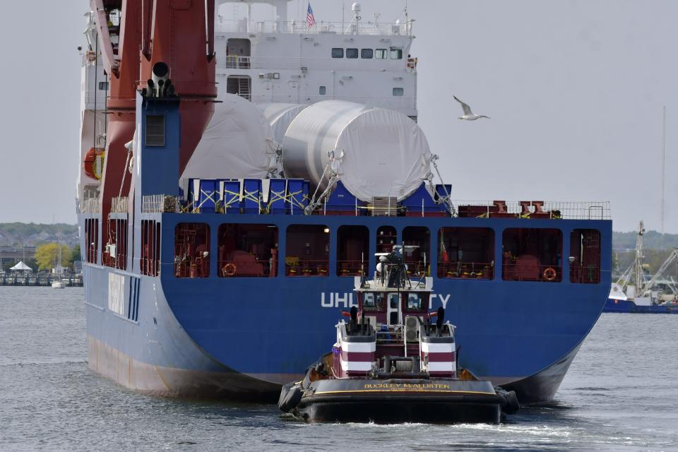 The ship UHL Felicity, carrying wind turbine tower sections, arrives Wednesday, May 24, 2023, to dock in New Bedford, Mass. Once assembled by developer Vineyard Wind, the turbines at sea will stand more than 850 feet high. (AP Photo/Josh Reynolds)