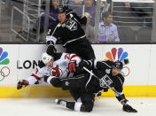 LOS ANGELES, CA - JUNE 11: Matt Greene #2 and Jordan Nolan #71 of the Los Angeles Kings check Ryan Carter #20 of the New Jersey Devils in first period of Game Six of the 2012 Stanley Cup Final at Staples Center on June 11, 2012 in Los Angeles, California. (Photo by Jeff Gross/Getty Images)