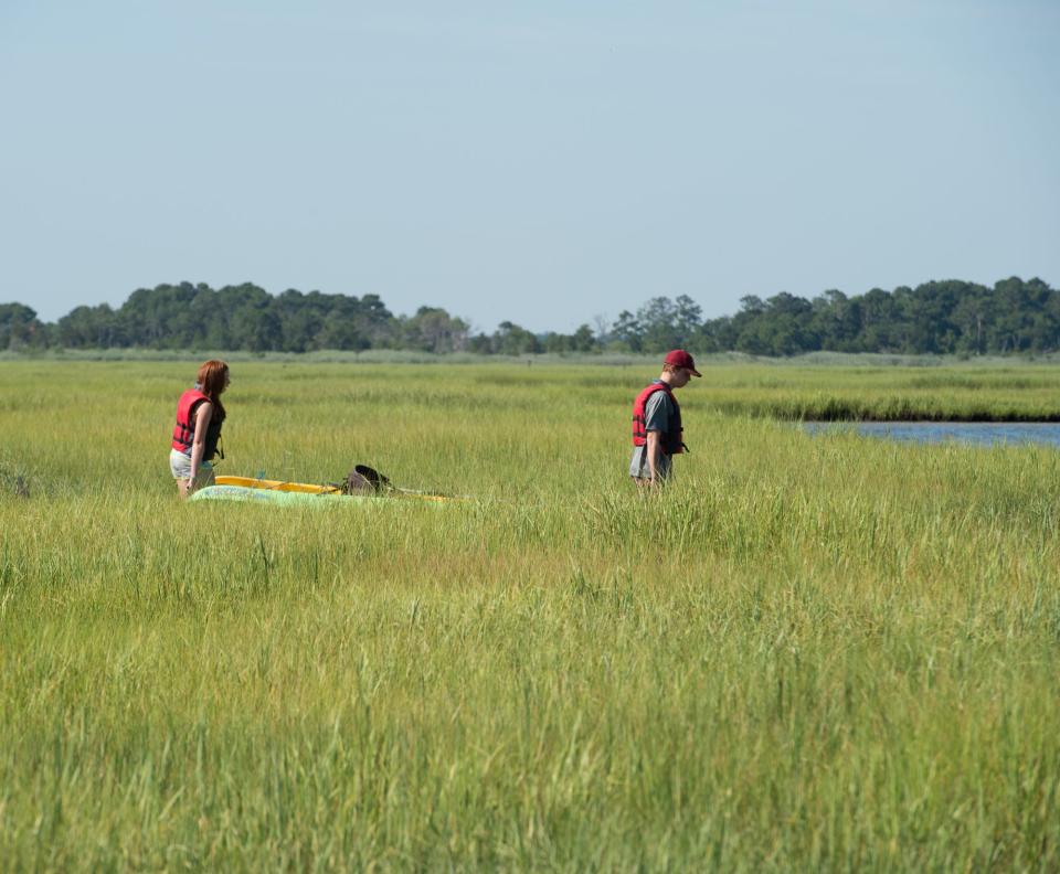 Kayakers carrying their kayak to the Rehoboth Bay in 2018.