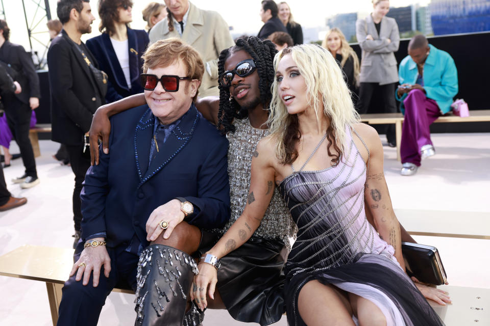 Elton John, Lil Nas X and Miley Cyrus on the front row at Versace’s fall winter ’23 show in L.A. - Credit: Getty Images
