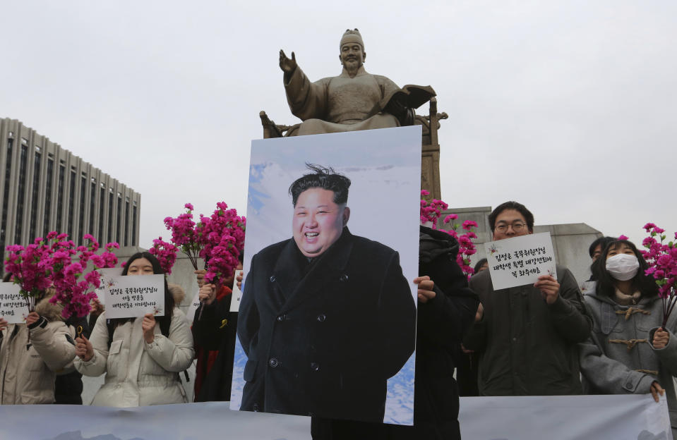 South Korean college students stand with a portrait of North Korean leader Kim Jong Un during a rally to welcome his possible visit to South Korea, in Seoul, South Korea, Thursday, Jan. 31, 2019. Secretary of State Mike Pompeo says he is sending a team "someplace in Asia" to set up a second summit between President Donald Trump and North Korean leader Kim Jong Un by the end of February. The signs read " We welcome North Korean leader Kim Jong Un's visit." (AP Photo/Ahn Young-joon)