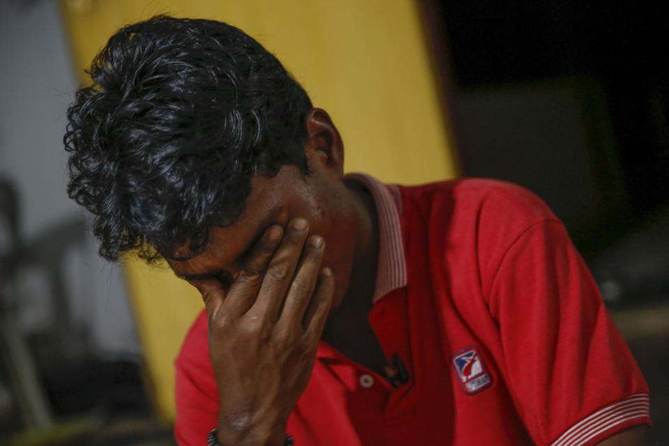 In this Nov. 23, 2013 photo, Rohingya refugee Mohamad Husein, from Myanmar, wipes tears from his eyes as he talks to reporters at his hostel on the outskirts of Alor Setar, Kedah, North Malaysia. After his tiny Muslim village in Myanmar's northwest Rakhine had been destroyed in a fire set by an angry Buddhist mob, he and his younger sister became separated from their family. (AP Photo/Vincent Thian)