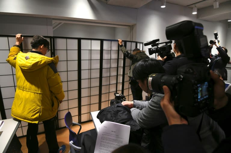 An anonymous South Korean actress speaks from behind a screen during a press conference accusing Kim of abusing her