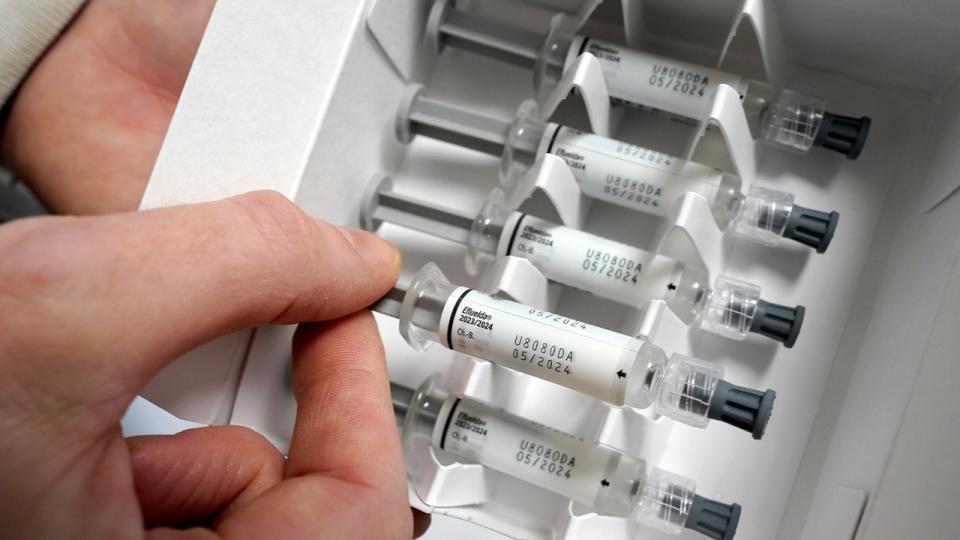 <div>A doctor pulls a vaccine dose from a package containing a flu vaccine. <strong>(Photo by Marcus Brandt/picture alliance via Getty Images)</strong></div>