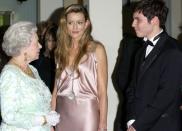 <p>While attending the premiere of <em>The Truman Show, </em>actress Natascha McElhone chatted with Queen Elizabeth while wearing a slinky, pink silk dress.</p>