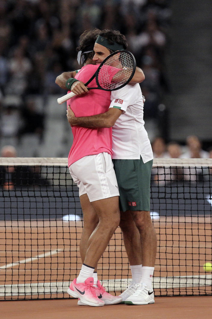 FILE - In this Feb. 7, 2020, file photo, Roger Federer, right, and Rafael Nadal embrace after the final point of their exhibition tennis match held at the Cape Town Stadium in Cape Town, South Africa. (AP Photo/Halden Krog, File)