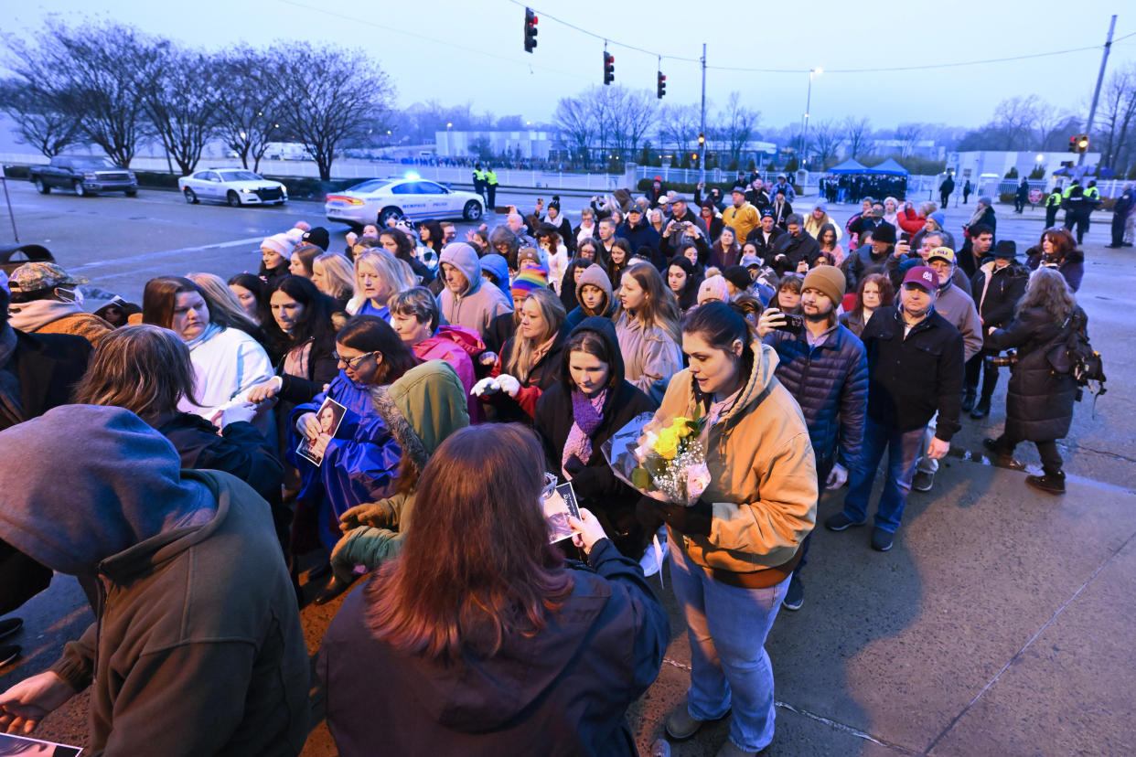 Fans line up to enter Graceland for a memorial service for Lisa Marie Presley Sunday, Jan. 22, 2023, in Memphis, Tenn. She died Jan. 12 after being hospitalized for a medical emergency and was buried on the property next to her son Benjamin Keough, and near her father Elvis Presley and his two parents. (AP Photo/John Amis)