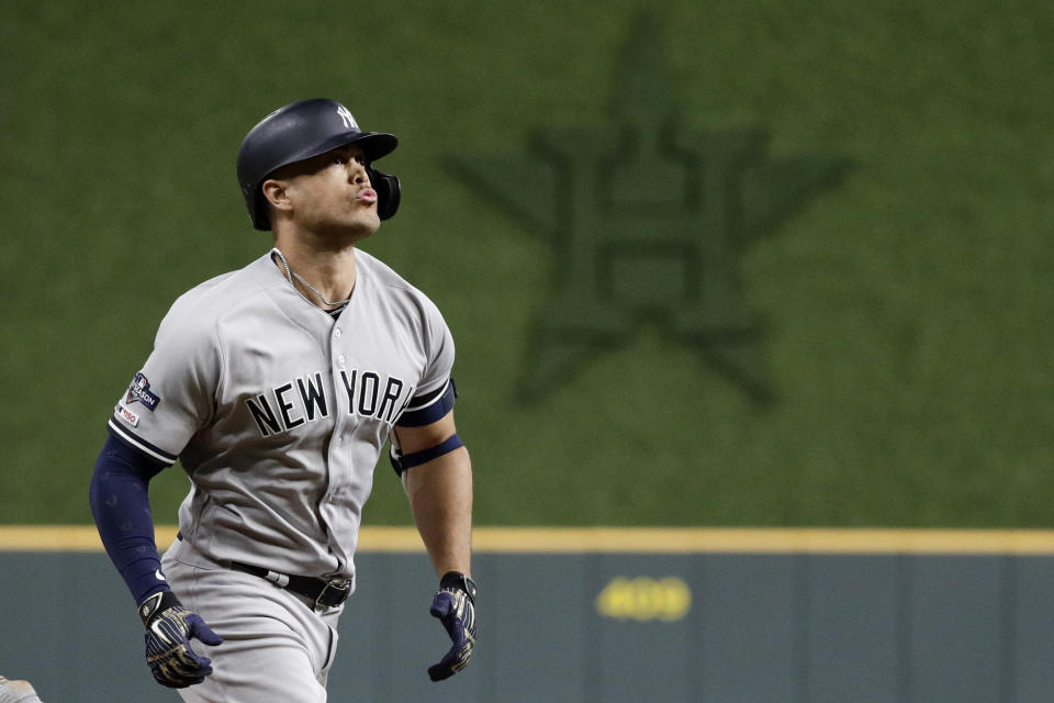 New York Yankees' Giancarlo Stanton rounds the bases after a home run during the sixth inning in Game 1 of baseball's American League Championship Series against the Houston Astros Saturday, Oct. 12, 2019, in Houston. (AP Photo/Eric Gay)