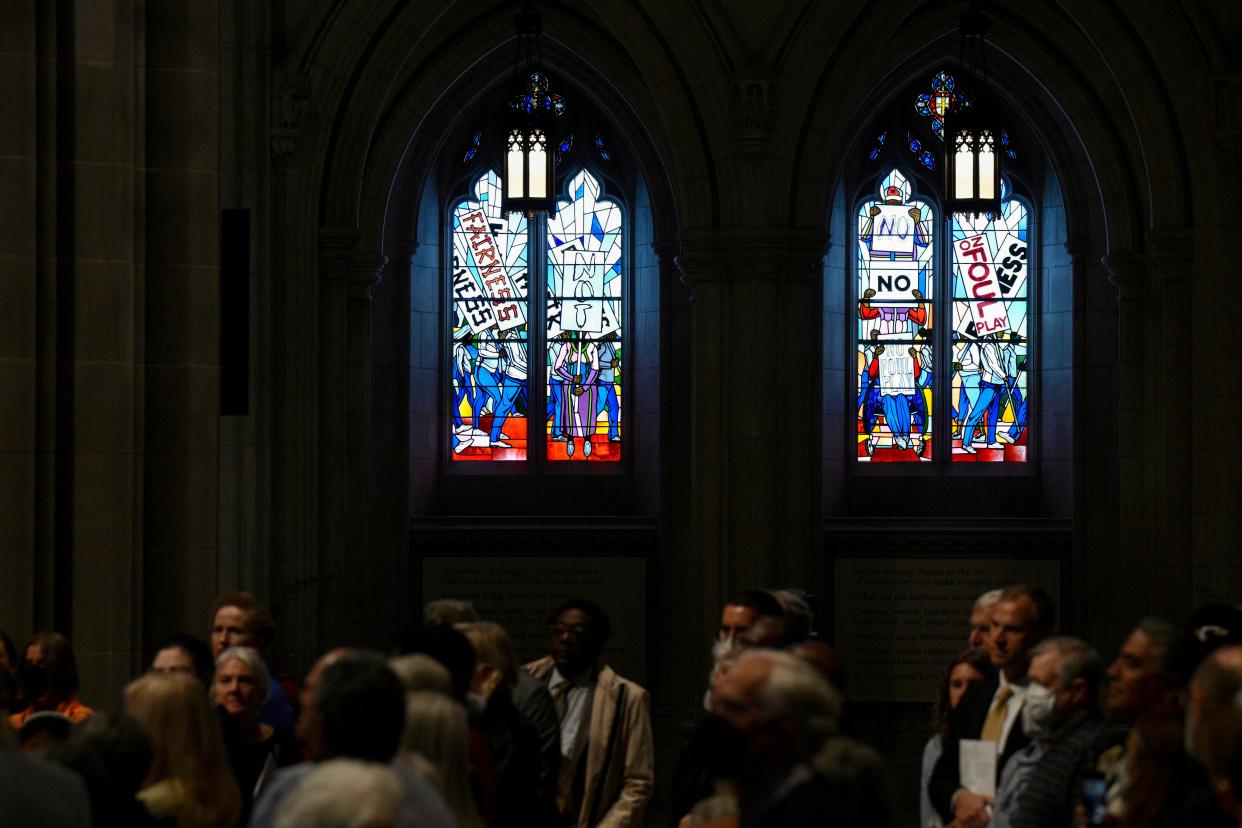 People listen during an unveiling and dedication ceremony Saturday at the Washington National Cathedral for the new stained-glass windows with a theme of racial justice. The new windows, titled “Now and Forever," are based on a design by artist Kerry James Marshall. Stained-glass artisan Andrew Goldkuhle crafted the windows based on that design.