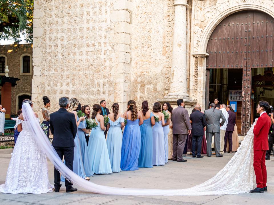 Bride and her bridesmaids preparing to enter a church.