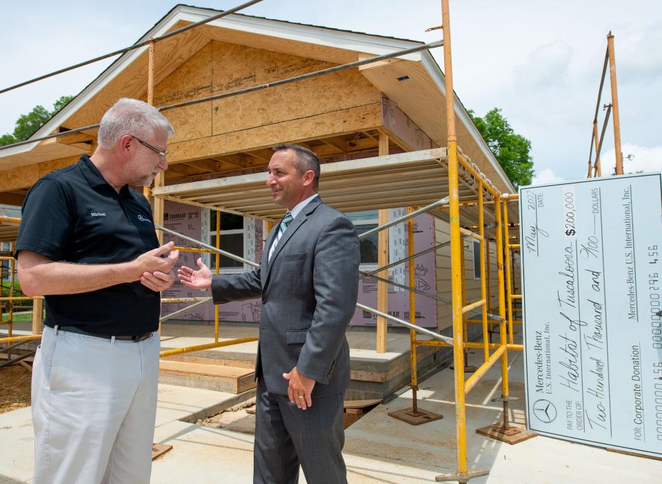 May 2, 2022; Tuscaloosa, AL, USA; Mercedes-Benz USI announced a partnership with Habitat for Humanity Tuscaloosa in their Operation Transformation initiative Monday outside a home under construction on Ash Street where Barbara Bonner will live. Michael Goebel, president and CEO of MBUSI, talks with Tuscaloosa City Schools Superintendent Mike Daria outside the house being constructed. The new program will give students in building related programs at the Tuscaloosa Career and Technology Academy a chance to hone their skills on Habitat job sites. Mandatory Credit: Gary Cosby Jr.-The Tuscaloosa News