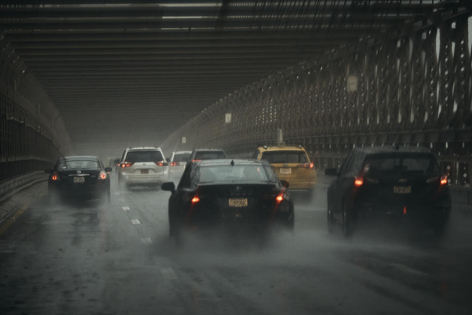 Cars move along Brooklyn Bridge under heavy rain on Friday, Sept. 29, 2023 in Brooklyn borough of New York. A potent rush-hour rainstorm swamped the New York metropolitan area on Friday, shutting down parts of the city’s subway system, flooding streets and highways, and delaying flights into LaGuardia Airport. (AP Photo/Andres Kudacki)