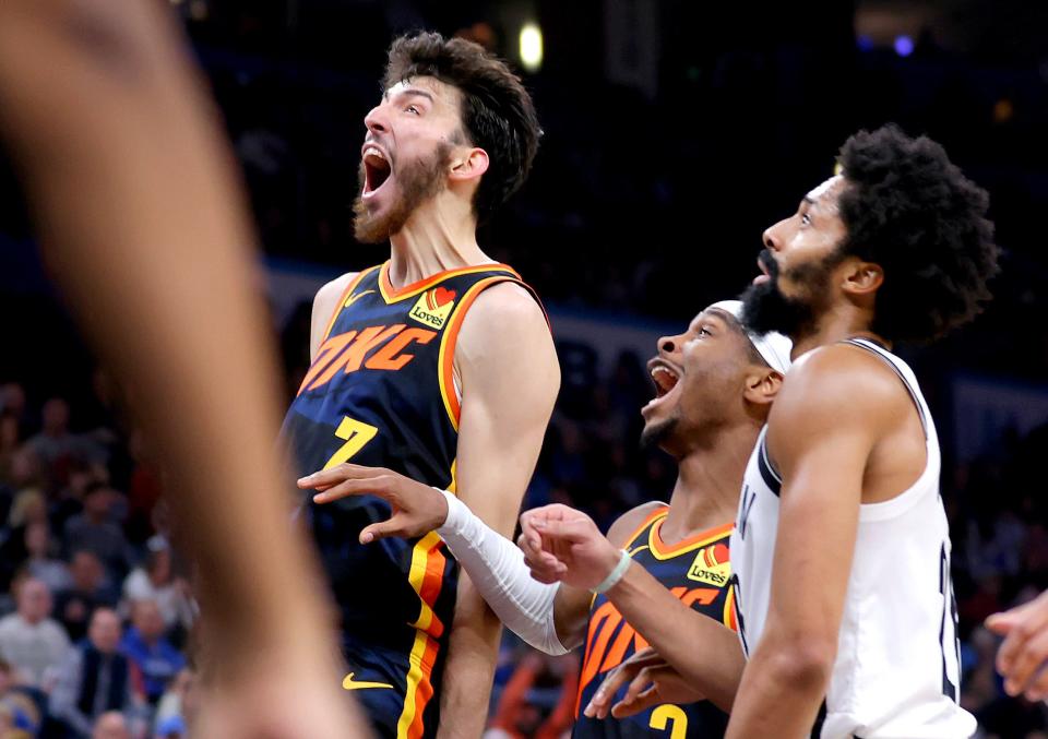 Thunder forward Chet Holmgren (7) and guard Shai Gilgeous-Alexander (2) react next to Nets guard Spencer Dinwiddie (26) during OKC's 124-108 win Sunday night.