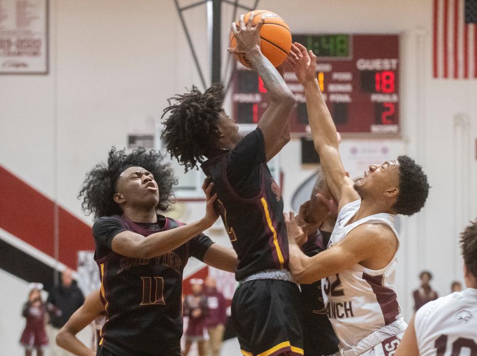 Edison's Daeleon Neal, left, and Leon Mills Jr. fight for a rebound with Weston Ranch's Caleb Butler, right, during a boys varsity basketball game at Weston Ranch in Stockton on Wednesday, Jan. 4, 2023.