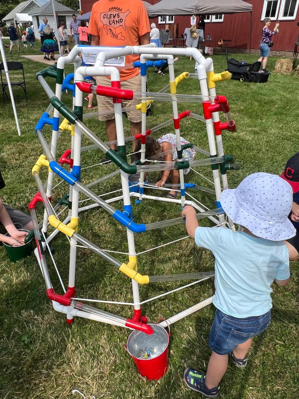 Children can run marbles along through this device at the Case-Barlow Farm's fall festival, in its 25th year.