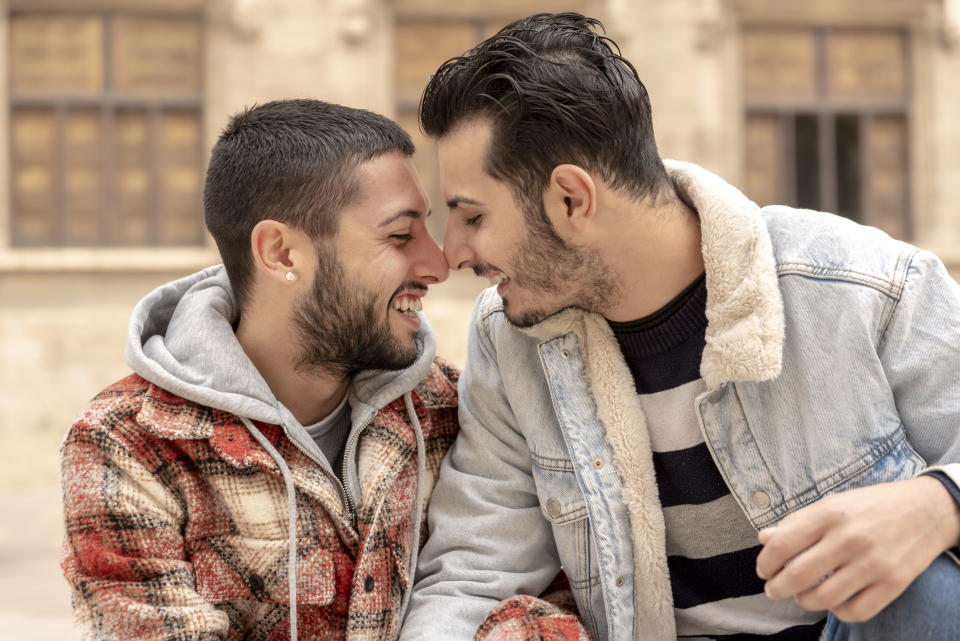 Couple laughing each Other face to face outdoors