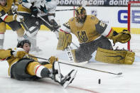 Vegas Golden Knights defenseman Nicolas Hague (14) slides across the ice after Vegas Golden Knights goaltender Marc-Andre Fleury (29) blocked a shot by the San Jose Sharks during the third period of an NHL hockey game Wednesday, March 17, 2021, in Las Vegas. (AP Photo/John Locher)
