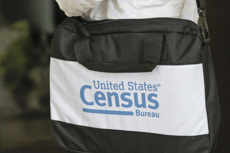 FILE - The briefcase of a census taker is seen as she knocks on the door of a residence, Aug. 11, 2020, in Winter Park, Fla. Eleven small cities in Illinois and Iowa are the only municipalities so far to have signed agreements with the U.S. Census Bureau for a second count of their residents in 2024, the first year the special censuses can be conducted, in a repeat of what happened during the 2020 census. (AP Photo/John Raoux, File)