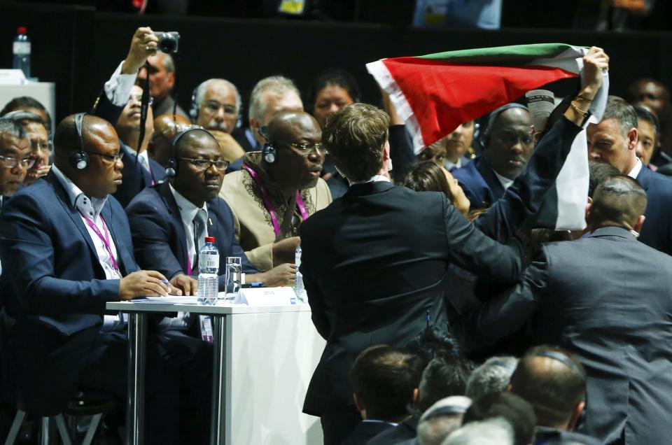 Security officers block a pro-Palestine protestor at the 65th FIFA Congress in Zurich