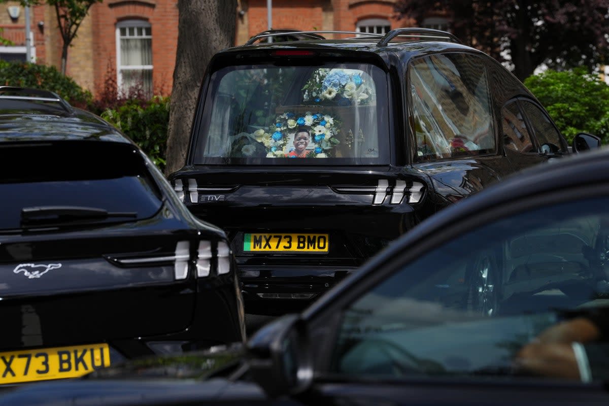 Floral tributes and a photograph placed in the hearse of Daniel Anjorin, following his funeral in Ilford (Jonathan Brady/PA Wire)