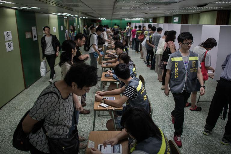 Voters cast their ballots at a polling station in an unofficial pro-democracy referendum in Hong Kong, on June 22, 2014
