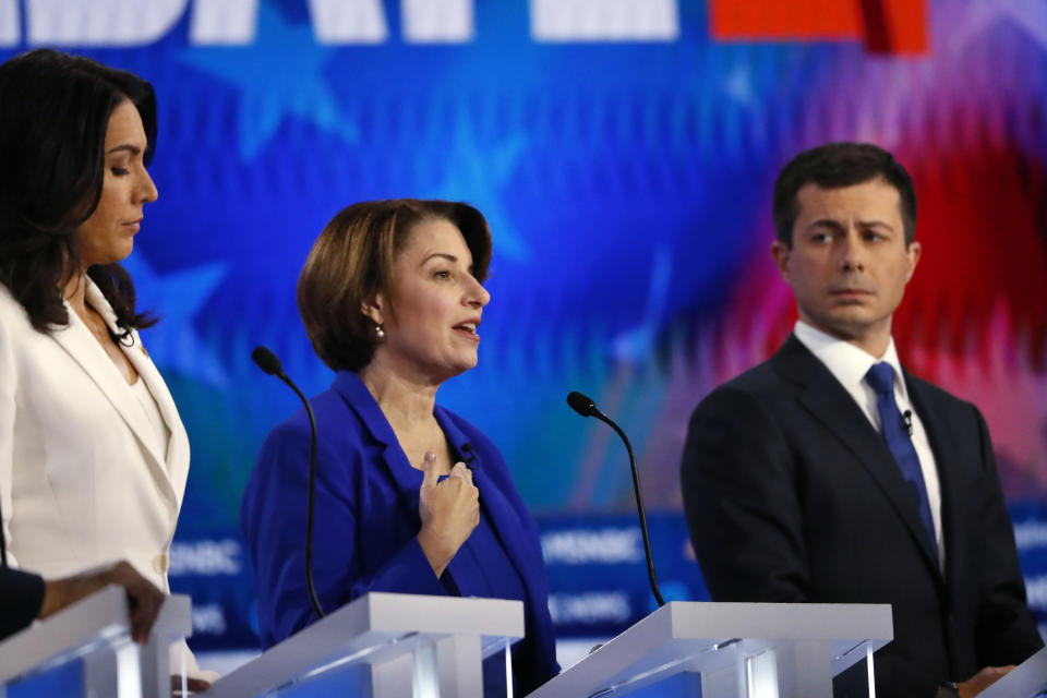 Democratic presidential candidate Sen. Amy Klobuchar, D-Minn., center speaks as Democratic presidential candidate Rep. Tulsi Gabbard, D-Hawaii, left and Democratic presidential candidate South Bend, Ind., Mayor Pete Buttigieg listen during a Democratic presidential primary debate, Wednesday, Nov. 20, 2019, in Atlanta. (AP Photo/John Bazemore)