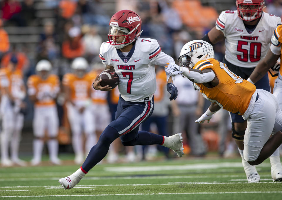 Liberty quarterback Kaidon Salter (7) avoids the tackle by UTEP linebacker Tyrice Knight (10) during the first half of an NCAA college football game on Saturday, Nov. 25, 2023, in El Paso, Texas. (AP Photo/Andres Leighton)