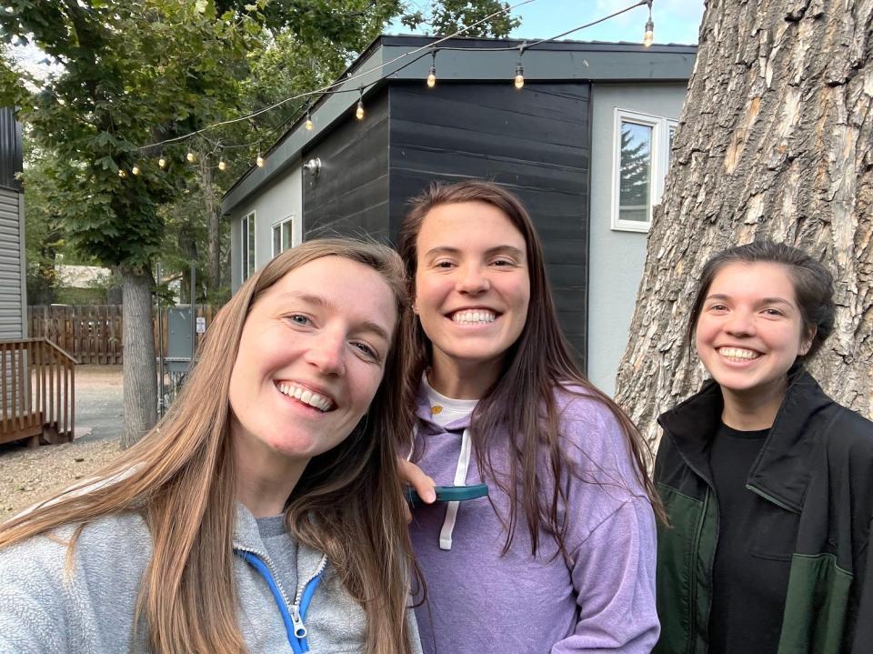 The three of us in front of our tiny house.