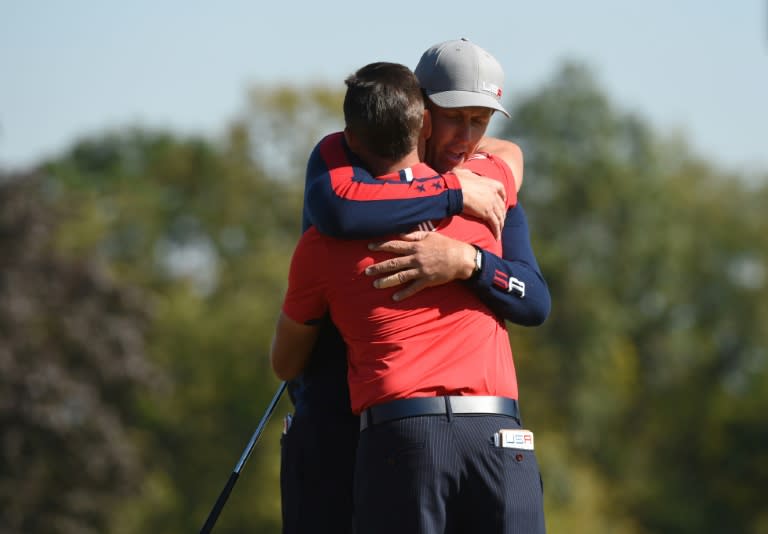 Team USA Phil Mickelson and Rickie Fowler hug after defeating Team Europe Rory McIlroy and Andy Sullivan