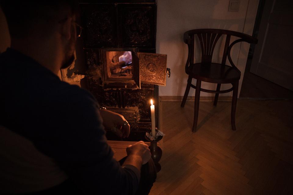 Petro, 26 years old, lights an old stove to provide heat for a home without electricity (Getty)