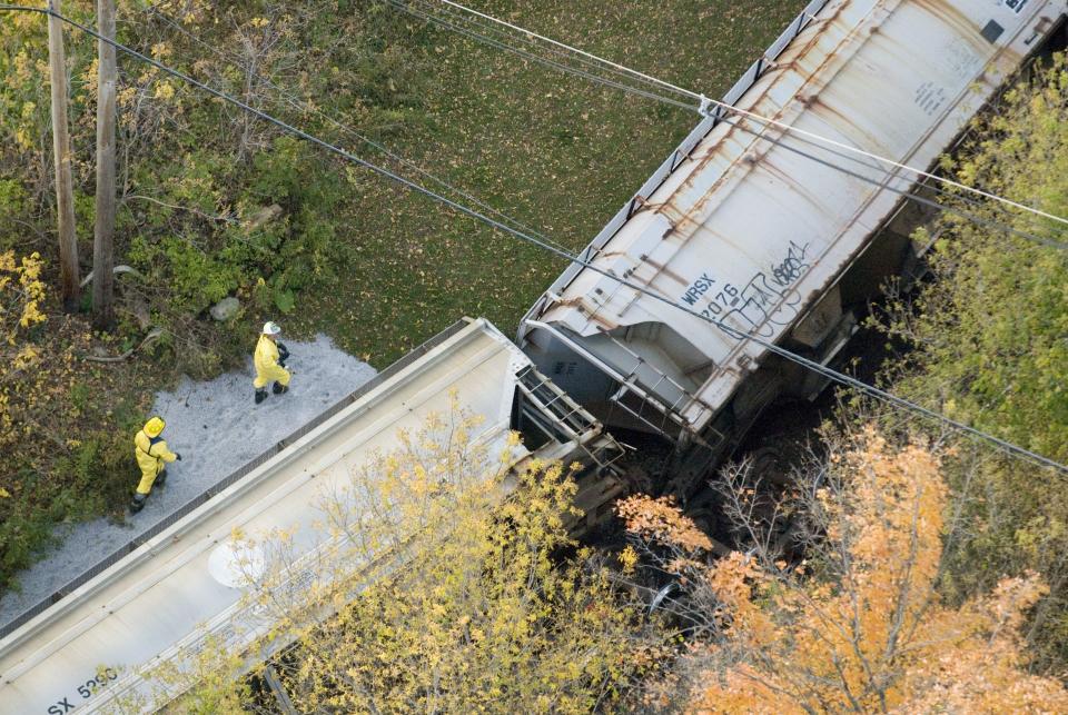 Emergency hazmat crews work to secure a freight train after several cars flipped over in downtown Middlebury in 2007.