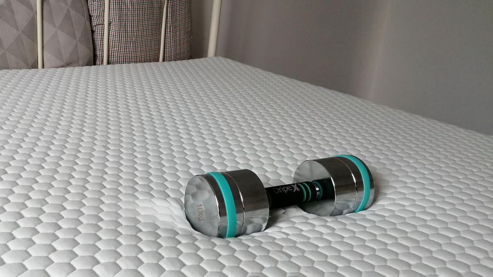 Lola Cool Hybrid mattress in reviewer's bedroom, with weight resting on it