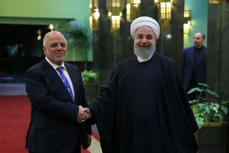 Iranian President Hassan Rouhani shakes hands with Iraqi Prime Minister Haider Al-Abadi, in Tehran, Iran, October 26, 2017. President.ir/Handout via REUTERS ATTENTION EDITORS - THIS PICTURE WAS PROVIDED BY A THIRD PARTY. NO RESALES. NO ARCHIVE.