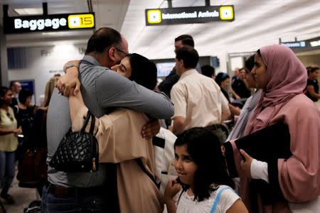 A family embraces each other as members arrive at Washington Dulles International Airport after the U.S. Supreme Court granted parts of the Trump administration's emergency request to put its travel ban into effect later in the week pending further judicial review, in Dulles, Virginia, U.S., June 26, 2017. REUTERS/James Lawler Duggan