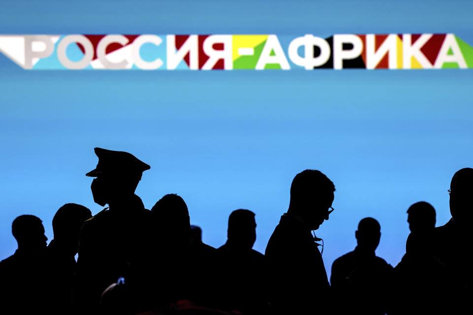 Participants are seen silhouetted ahead of the plenary session of the Russia-Africa Summit and Economic and Humanitarian Forum in St. Petersburg, Russia, Thursday, July 27, 2023. (Valery Sharifulin/TASS Host Photo Agency Pool Photo via AP)