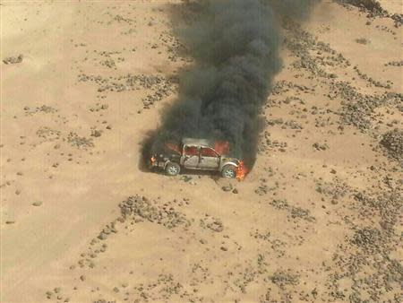 Handout photo of a pickup truck on fire after it was hit by a Jordanian warplane following failure to heed warnings not to cross into Jordan from Syria April 16, 2014. REUTERS/www.ammonnews.net/Handout via Reuters