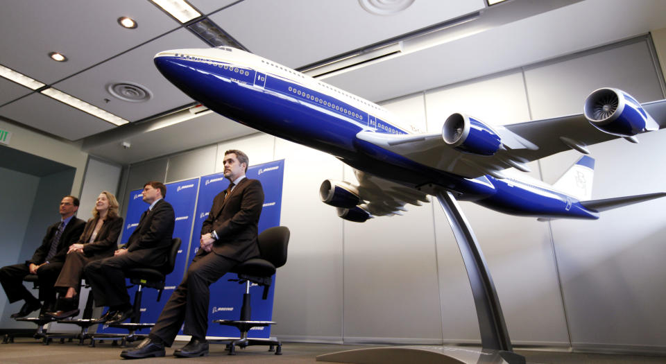 747 communications manager Jim Proulx, right, sits near a model of the first Boeing 747-8 Intercontinental jet during a news conference about the first delivery of the aircraft Tuesday, Feb. 28, 2012, in Everett, Wash. From left are Bruce Dickinson, vice president and chief project engineer for the 747-8, Elizabeth Lund, vice president and general manager of the 747 program, and Steve Taylor, president of Boeing Business Jets. The airplane was scheduled to fly away from Paine Field there later in the day. The new 747-8 Intercontinental is expected to deliver double-digit gains in fuel efficiency over the 747-400 and provide VIP customers and passenger airlines, such as Lufthansa, with the lowest operating costs and best economics of any airplane in its class. Lufthansa is scheduled to take delivery of its first 747-8 Intercontinental early this year. (AP Photo/Elaine Thompson)