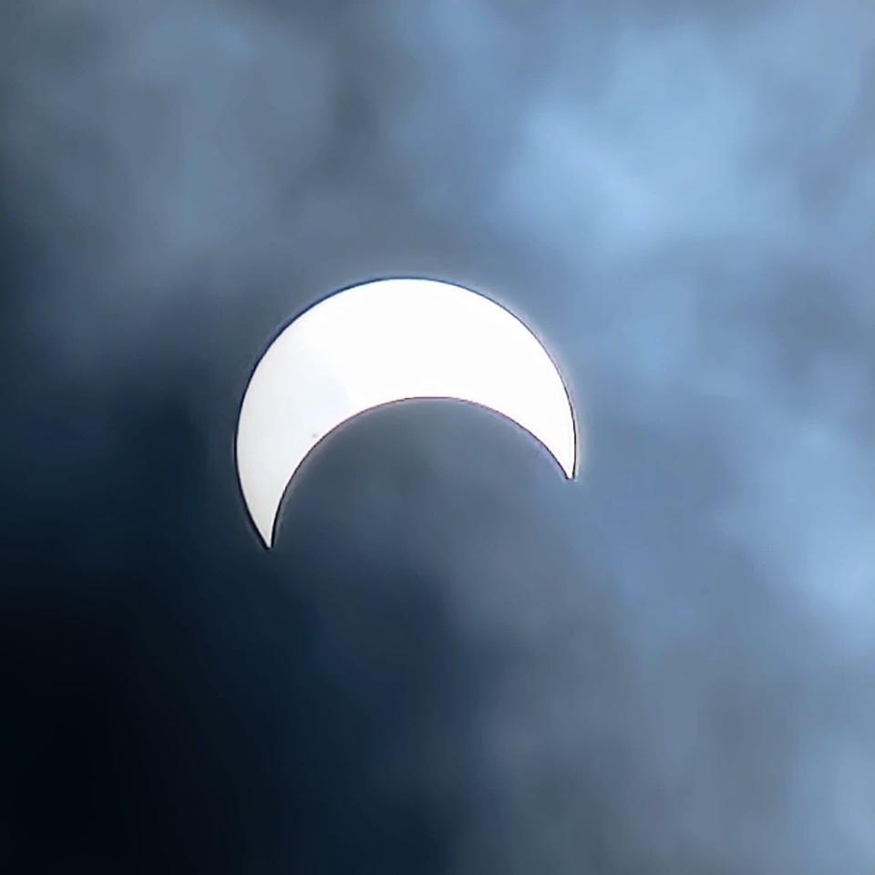 This photo of the solar eclipse over South Florida on Saturday, Oct. 14, 2023, was taken by placing eclipse glasses over a cellphone camera lens.