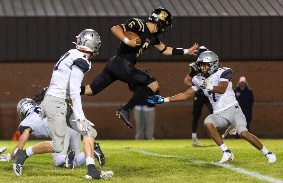 Boonville’s Clay Conner (6) leaps while running the ball as the Boonville Pioneers play the Reitz Panthers at Bennett Field in Boonville, Ind., Friday evening, Oct. 22, 2021. 